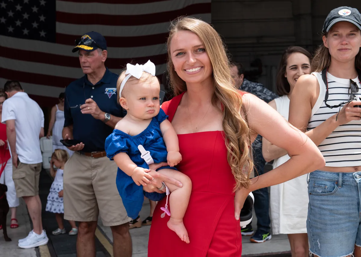 Military spouse with child at community event